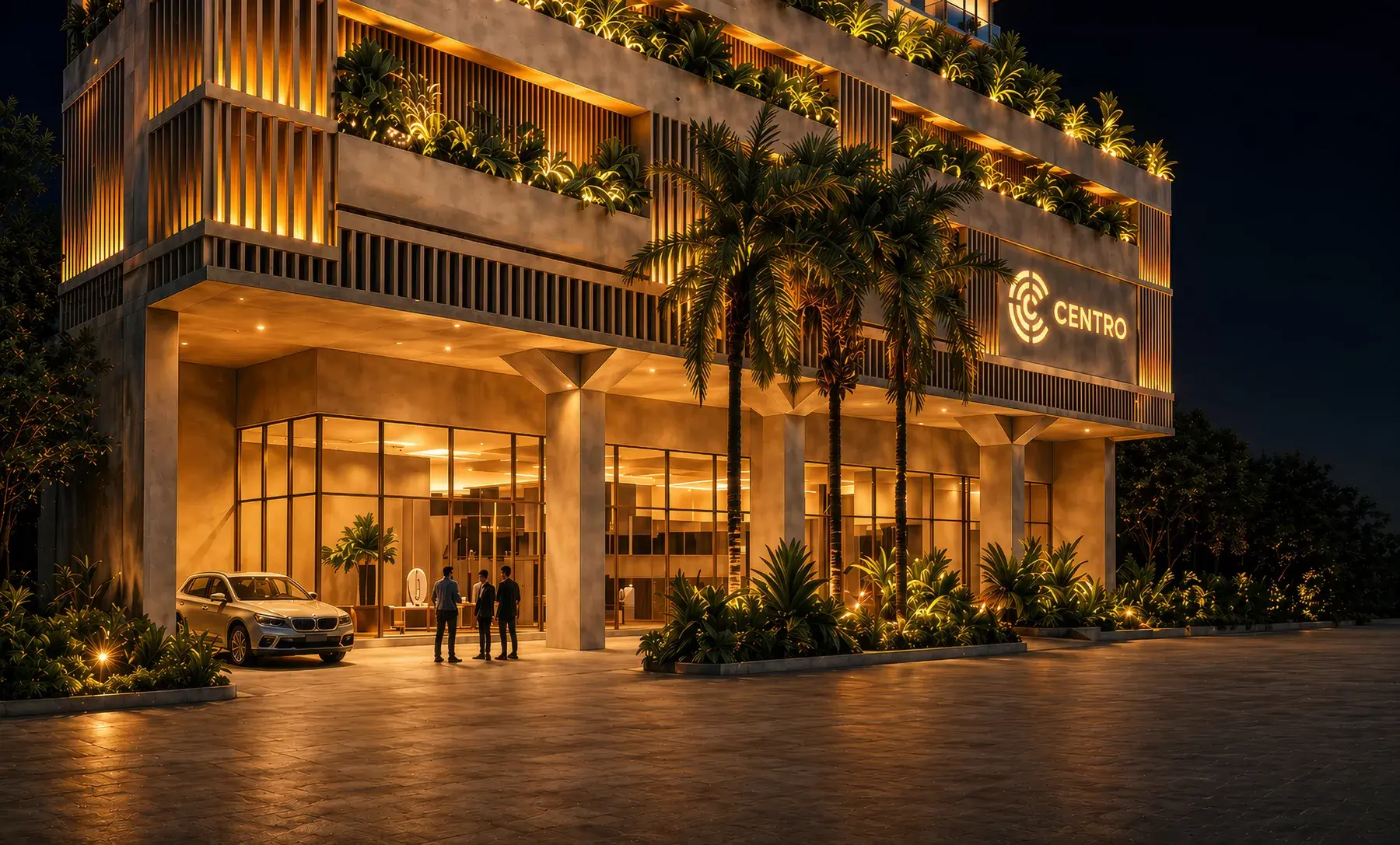 Centro Obarrio's entrance at night, with a covered drop-off, palms and the illuminated CENTRO sign above the lobby glazing