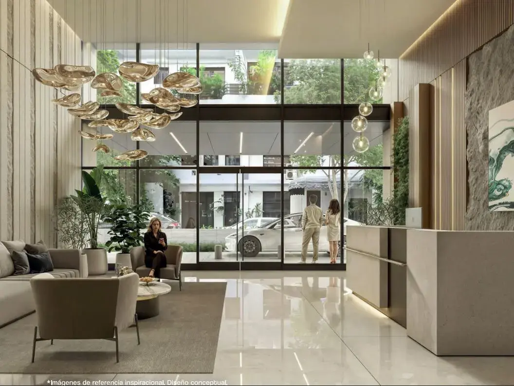 The Seaside lobby, with a sculptural pendant, lounge seating and glazing onto the entrance court