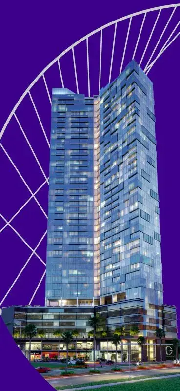 Generation Tower lit at night, its glazed facade set against a graphic purple backdrop