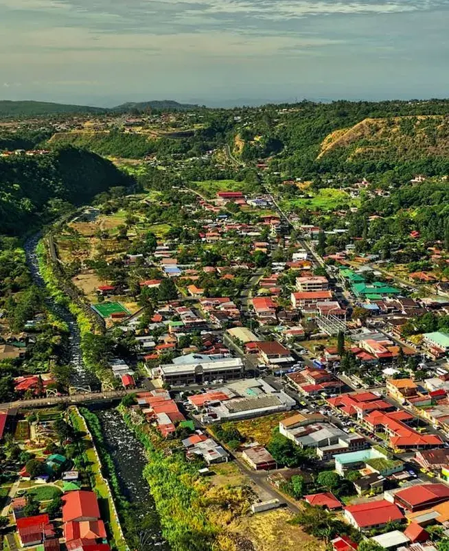 Aerial view of Boquete town in its river valley, with the surrounding hills and coffee country