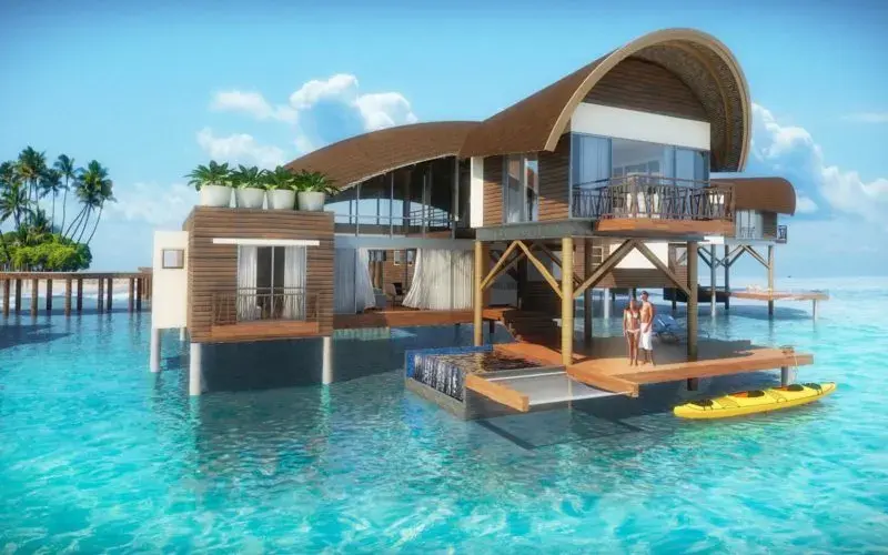 Rendering of an overwater villa at Playa Escondida, with a curved roof and a deck onto the shallows