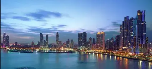 The Panama City skyline at dusk from the bay, towers lit along the waterfront